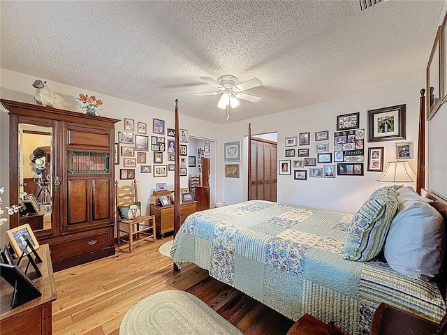 75 N Canal Dr, Palm Harbor, FL 34684 - bedroom featuring a textured ceiling, ceiling fan, and light wood-style flooring
