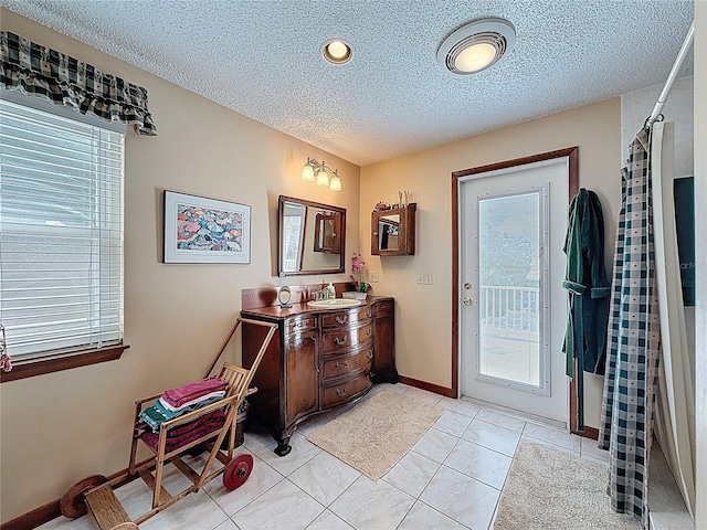 75 N Canal Dr, Palm Harbor, FL 34684 - interior space with light tile patterned floors, a textured ceiling, visible vents, and a healthy amount of sunlight