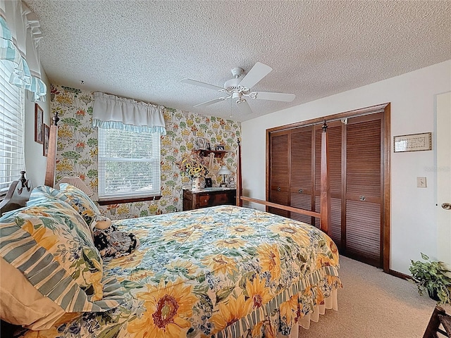 75 N Canal Dr, Palm Harbor, FL 34684 - carpeted bedroom with a closet, baseboards, wallpapered walls, a textured ceiling, and a ceiling fan