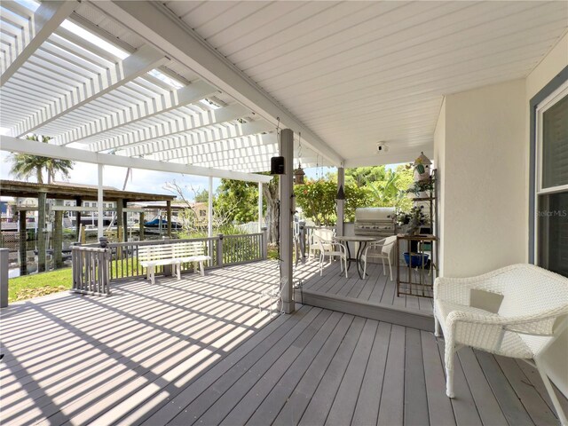 75 N Canal Dr, Palm Harbor, FL 34684 - wooden deck featuring a pergola and a grill