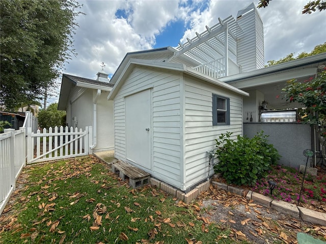 75 N Canal Dr, Palm Harbor, FL 34684 - exterior space with fence, a chimney, and an outdoor structure