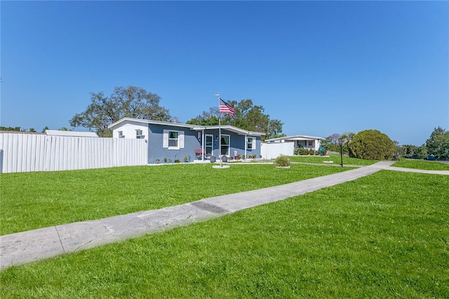 manufactured / mobile home featuring a front lawn and fence