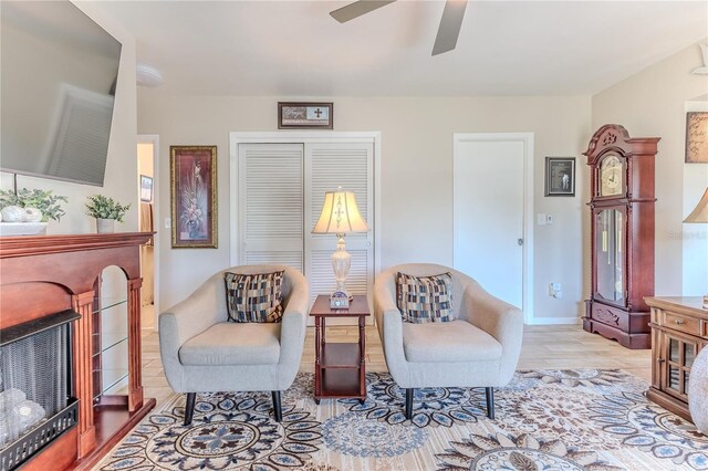 sitting room featuring ceiling fan and wood finished floors