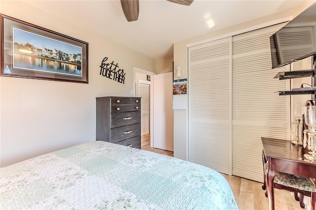 bedroom featuring a closet, a ceiling fan, and wood finished floors