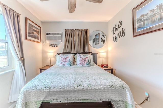 bedroom with ceiling fan and a wall mounted air conditioner