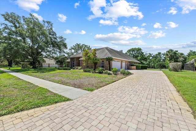 888 Royal Birkdale Dr, Tarpon Springs, FL 34688 - view of front of property with decorative driveway, a garage, and a front yard