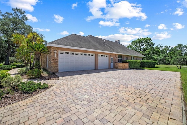 888 Royal Birkdale Dr, Tarpon Springs, FL 34688 - view of front of house with decorative driveway and an attached garage