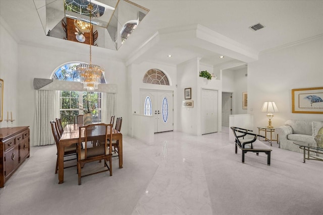 888 Royal Birkdale Dr, Tarpon Springs, FL 34688 - dining space featuring crown molding, a chandelier, marble finish floor, a towering ceiling, and visible vents