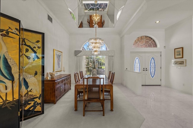 888 Royal Birkdale Dr, Tarpon Springs, FL 34688 - dining area with an inviting chandelier, ornamental molding, a high ceiling, and visible vents