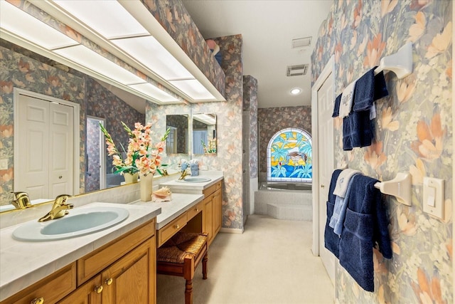 888 Royal Birkdale Dr, Tarpon Springs, FL 34688 - bathroom featuring vanity, wallpapered walls, a tub to relax in, and visible vents