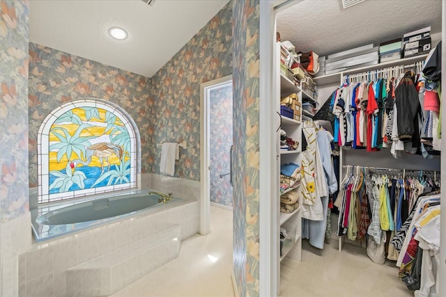 888 Royal Birkdale Dr, Tarpon Springs, FL 34688 - full bathroom featuring wallpapered walls, a walk in closet, and a garden tub