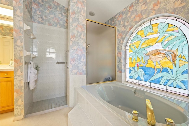 888 Royal Birkdale Dr, Tarpon Springs, FL 34688 - full bathroom featuring a garden tub, vanity, a healthy amount of sunlight, tiled shower, and wallpapered walls