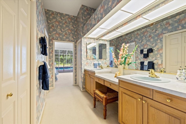 888 Royal Birkdale Dr, Tarpon Springs, FL 34688 - bathroom with double vanity, wallpapered walls, and a sink