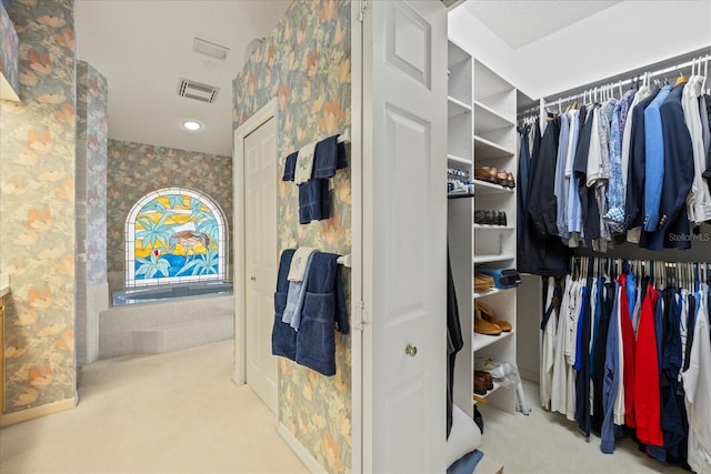 888 Royal Birkdale Dr, Tarpon Springs, FL 34688 - walk in closet featuring visible vents and carpet flooring