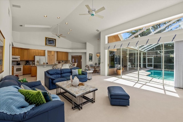 888 Royal Birkdale Dr, Tarpon Springs, FL 34688 - living area featuring ceiling fan, a sunroom, high vaulted ceiling, light colored carpet, and recessed lighting