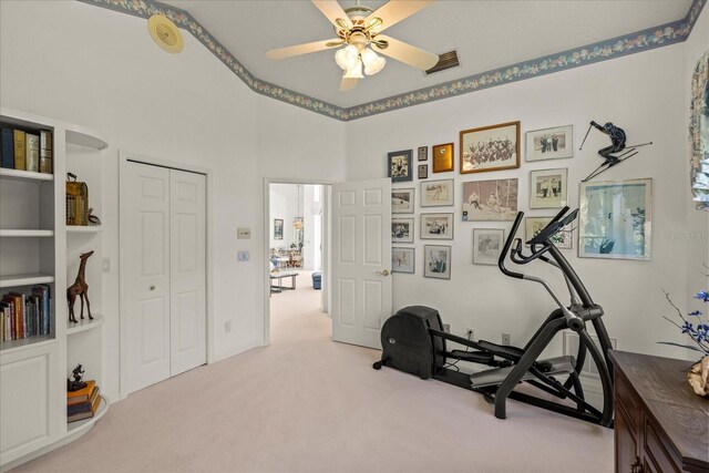 888 Royal Birkdale Dr, Tarpon Springs, FL 34688 - workout room with visible vents, carpet flooring, a towering ceiling, and a ceiling fan