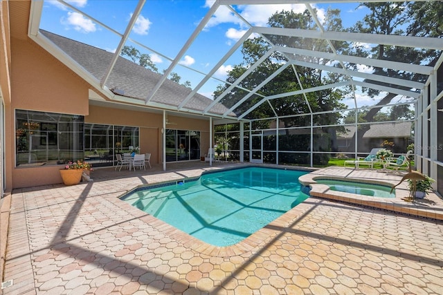 888 Royal Birkdale Dr, Tarpon Springs, FL 34688 - view of swimming pool featuring a patio, glass enclosure, and a pool with connected hot tub