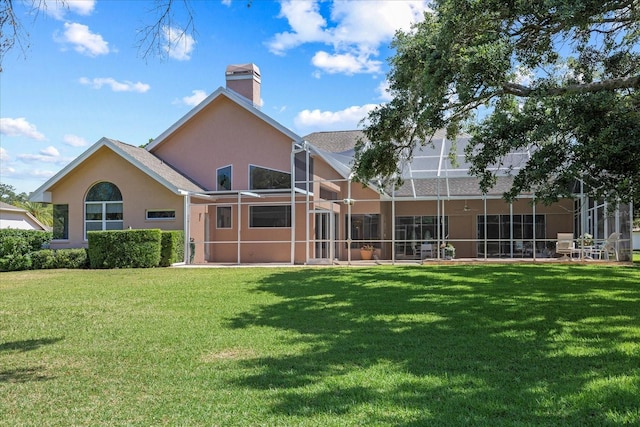 888 Royal Birkdale Dr, Tarpon Springs, FL 34688 - back of house with a lawn, a chimney, glass enclosure, and stucco siding