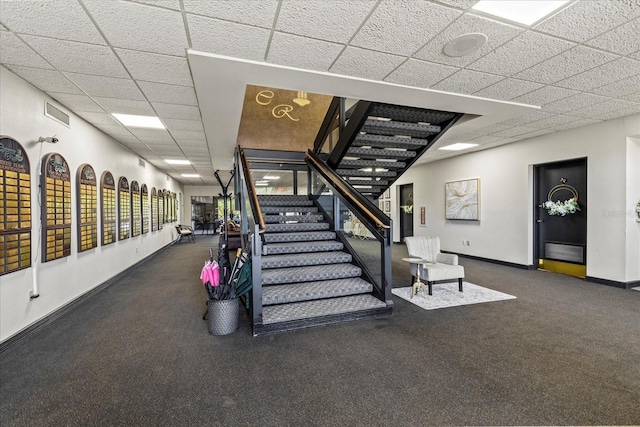 888 Royal Birkdale Dr, Tarpon Springs, FL 34688 - stairs featuring carpet floors, baseboards, visible vents, and a drop ceiling