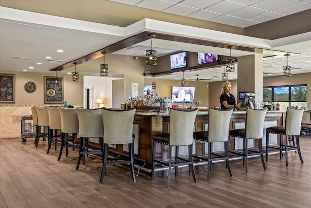 888 Royal Birkdale Dr, Tarpon Springs, FL 34688 - kitchen featuring a breakfast bar, recessed lighting, wood finished floors, and visible vents
