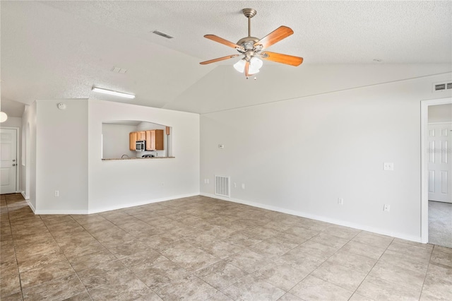 8461 Apple Orchard Rd, Spring Hill, FL 34608 - unfurnished living room featuring vaulted ceiling, ceiling fan, and a textured ceiling