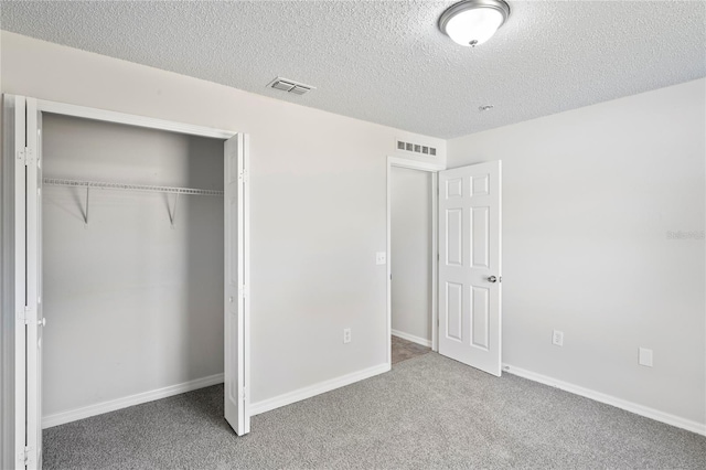 8461 Apple Orchard Rd, Spring Hill, FL 34608 - unfurnished bedroom with a closet, carpet, a textured ceiling, and baseboards