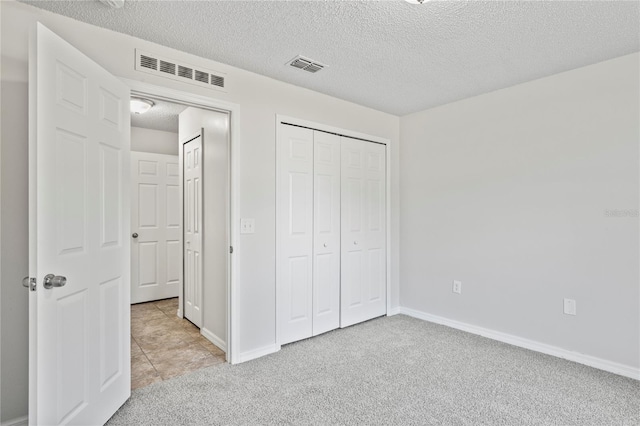 8461 Apple Orchard Rd, Spring Hill, FL 34608 - unfurnished bedroom featuring carpet floors, a textured ceiling, a closet, and baseboards