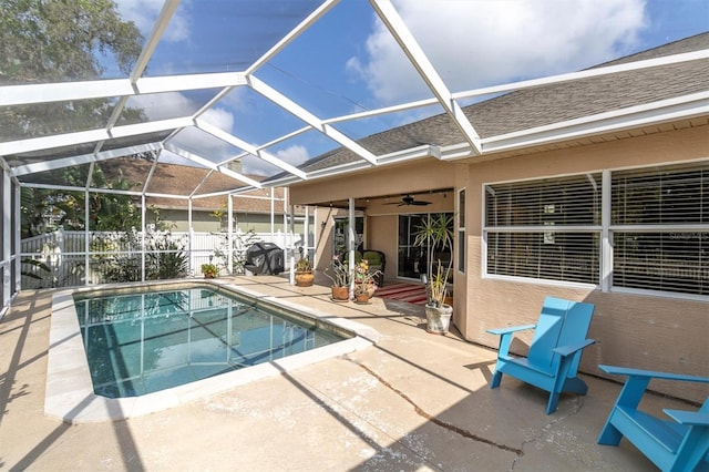 view of swimming pool with ceiling fan, fence, a fenced in pool, a patio area, and a lanai