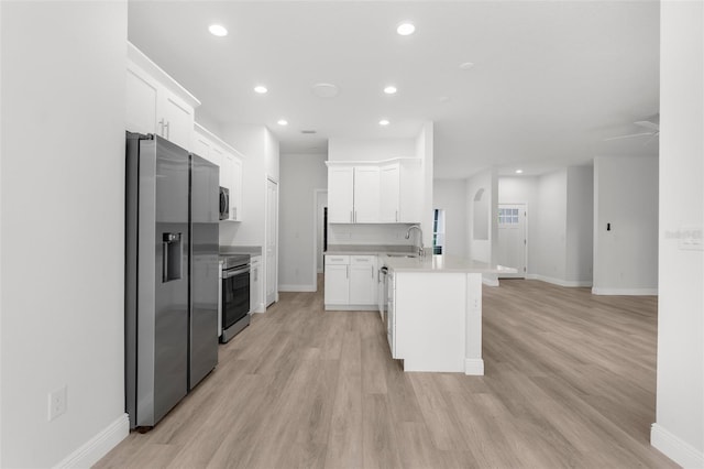 12331 Fulmar Rd, Weeki Wachee, FL 34614 - kitchen featuring stainless steel appliances, a peninsula, recessed lighting, and light wood-style floors