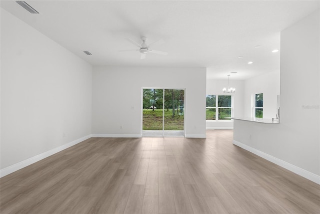 12331 Fulmar Rd, Weeki Wachee, FL 34614 - spare room featuring a chandelier, a ceiling fan, light wood-style flooring, and recessed lighting