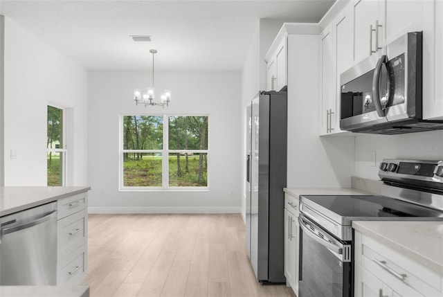 12331 Fulmar Rd, Weeki Wachee, FL 34614 - kitchen with appliances with stainless steel finishes, light countertops, and white cabinetry