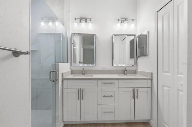 12331 Fulmar Rd, Weeki Wachee, FL 34614 - bathroom with double vanity, a marble finish shower, and a closet