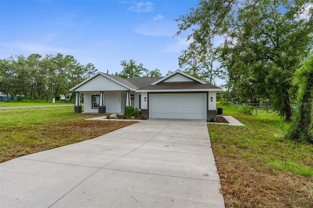 12331 Fulmar Rd, Weeki Wachee, FL 34614 - view of front facade with an attached garage, driveway, stucco siding, and a shingled roof