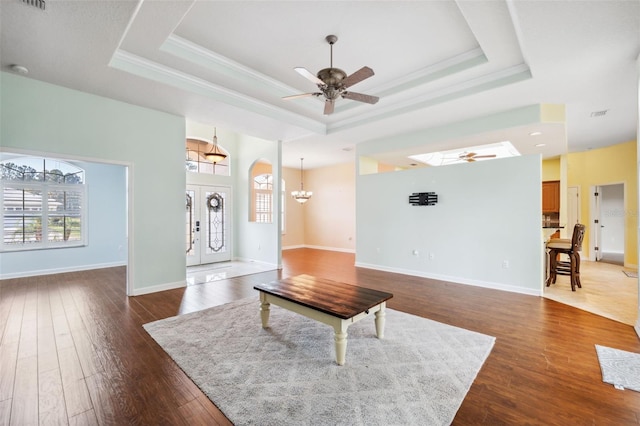 4080 Gevalia Dr, Brooksville, FL 34604 - unfurnished living room featuring crown molding, a tray ceiling, ceiling fan with notable chandelier, and a wealth of natural light