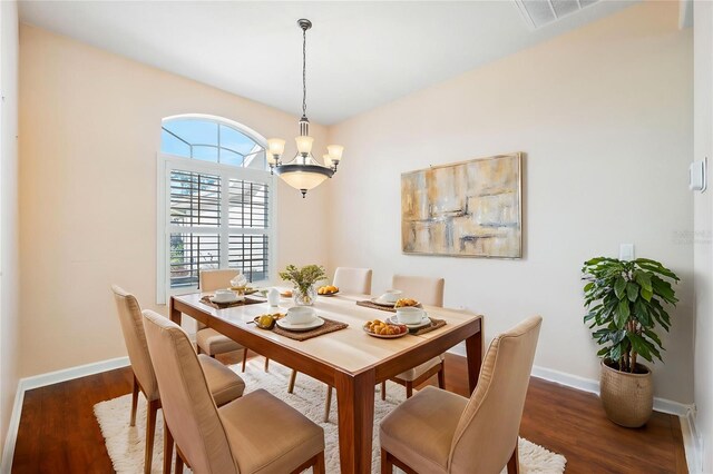 4080 Gevalia Dr, Brooksville, FL 34604 - dining area featuring baseboards, a notable chandelier, wood finished floors, and visible vents