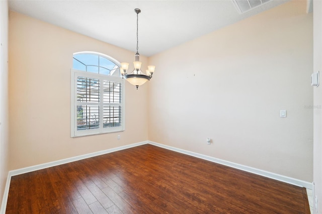 4080 Gevalia Dr, Brooksville, FL 34604 - unfurnished room featuring an inviting chandelier, baseboards, dark wood finished floors, and visible vents