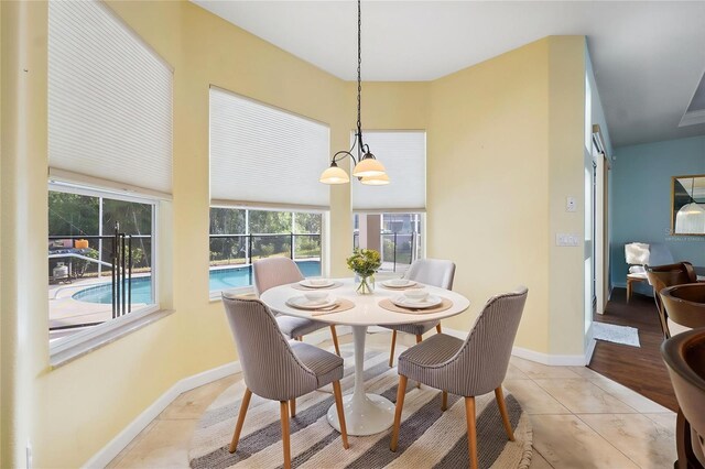 4080 Gevalia Dr, Brooksville, FL 34604 - dining room featuring light tile patterned floors, baseboards, and a notable chandelier