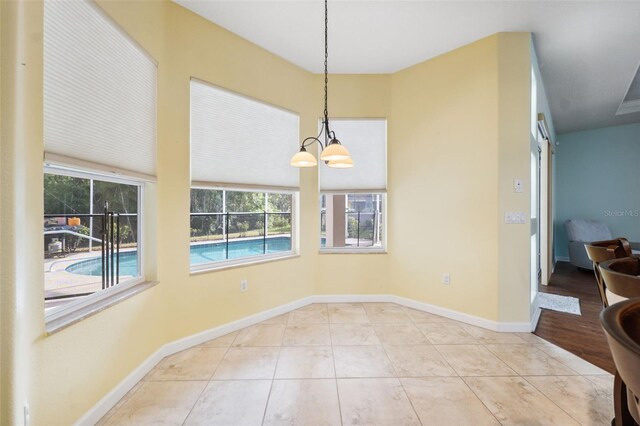 4080 Gevalia Dr, Brooksville, FL 34604 - unfurnished dining area with baseboards and a notable chandelier