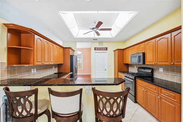 4080 Gevalia Dr, Brooksville, FL 34604 - kitchen featuring appliances with stainless steel finishes, open shelves, a kitchen bar, and a peninsula