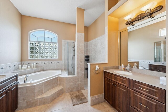 4080 Gevalia Dr, Brooksville, FL 34604 - full bath with walk in shower, a bath, two vanities, tile patterned floors, and a sink