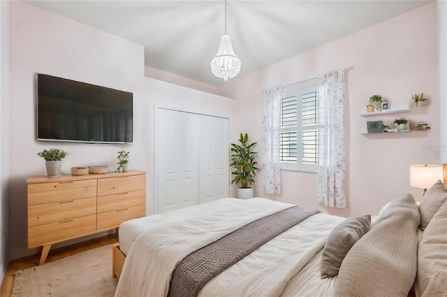 4080 Gevalia Dr, Brooksville, FL 34604 - bedroom featuring a closet, light wood-style flooring, and a chandelier