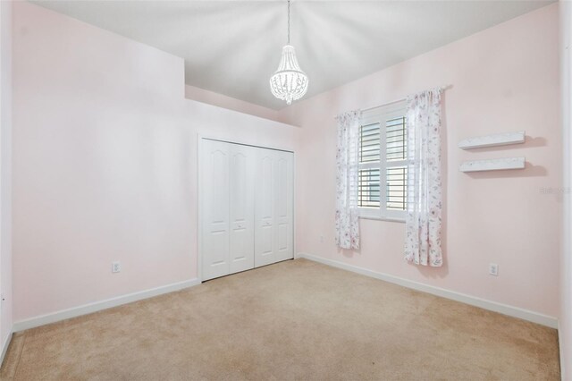 4080 Gevalia Dr, Brooksville, FL 34604 - unfurnished bedroom featuring baseboards, a chandelier, and carpet