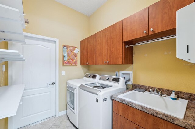 4080 Gevalia Dr, Brooksville, FL 34604 - laundry room with a sink, light tile patterned flooring, independent washer and dryer, and cabinet space