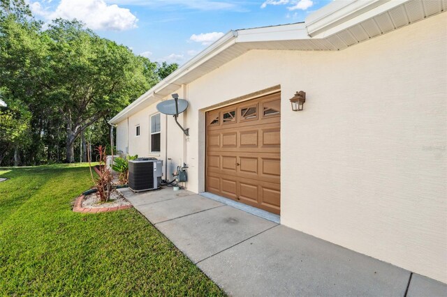 4080 Gevalia Dr, Brooksville, FL 34604 - view of property exterior featuring a lawn, an attached garage, cooling unit, and stucco siding