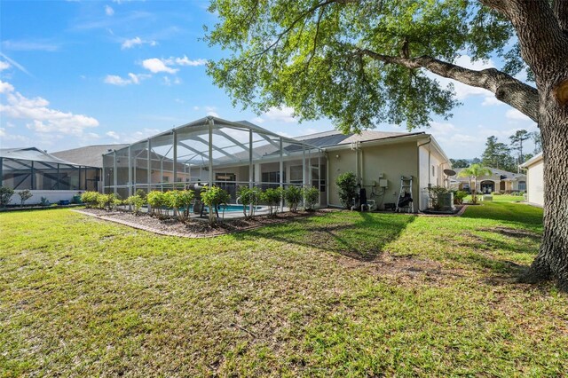 4080 Gevalia Dr, Brooksville, FL 34604 - back of house with a lawn, an outdoor pool, glass enclosure, and stucco siding