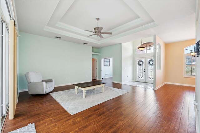 4080 Gevalia Dr, Brooksville, FL 34604 - living area featuring a tray ceiling, ceiling fan, french doors, and dark wood-type flooring