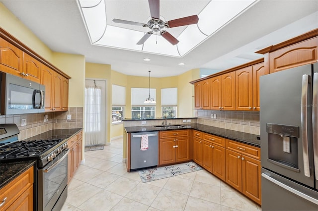 4080 Gevalia Dr, Brooksville, FL 34604 - kitchen with a ceiling fan, appliances with stainless steel finishes, tasteful backsplash, a sink, and a peninsula