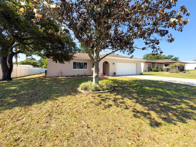 ranch-style home with fence, an attached garage, stucco siding, a front yard, and driveway