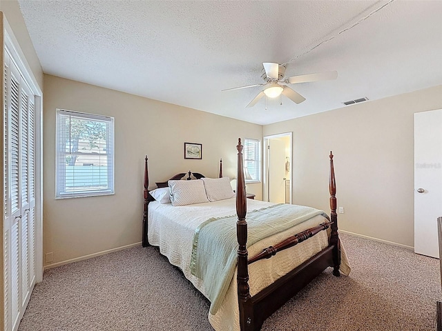 bedroom featuring visible vents, carpet, and baseboards