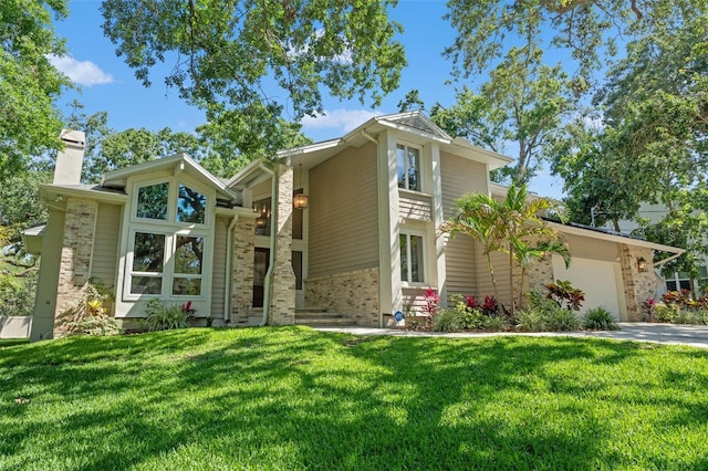 520 Lafayette Blvd, Oldsmar, FL 34677 - mid-century home featuring a front yard, brick siding, a chimney, and a garage
